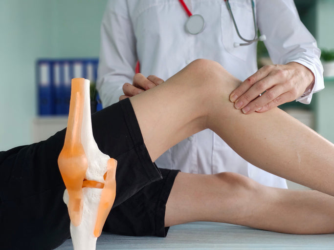 medical professional is examining a teenage patient knee due to pain